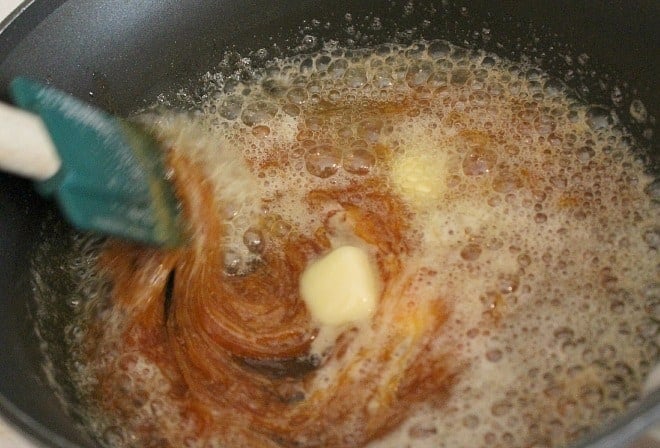Stirring homemade caramel sauce