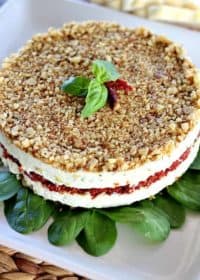 Cheese, Basil, and Sun Dried Tomato Torte is a beautiful alternative to your average party cheeseball. Can be made days ahead of serving.
