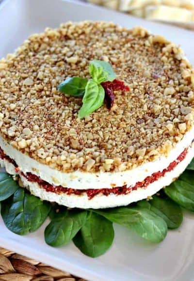 Cheese, Basil, and Sun Dried Tomato Torte is a beautiful alternative to your average party cheeseball. Can be made days ahead of serving.