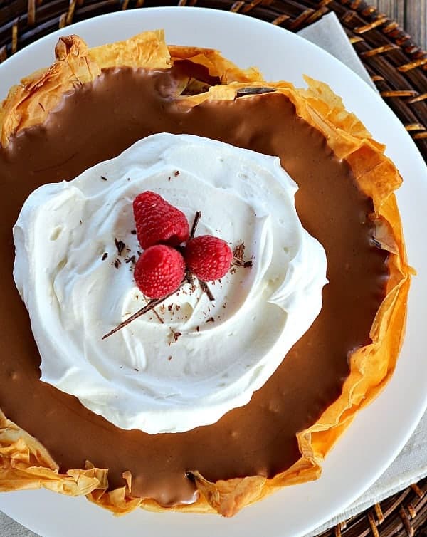 Chocolate Mousse Pie with Phyllo Crust topped with whipped cream and raspberries