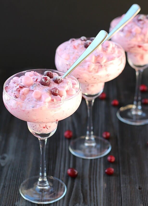 cranberry salad in tall glasses with spoons in them 