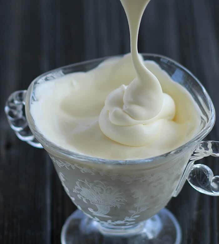 Creme Fraiche being poured in a small glass bowl