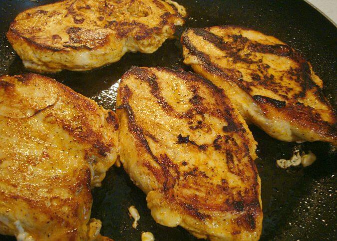 Browned chicken breasts in pan