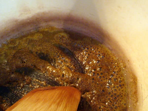 spiced being cooked and stirred in a pan
