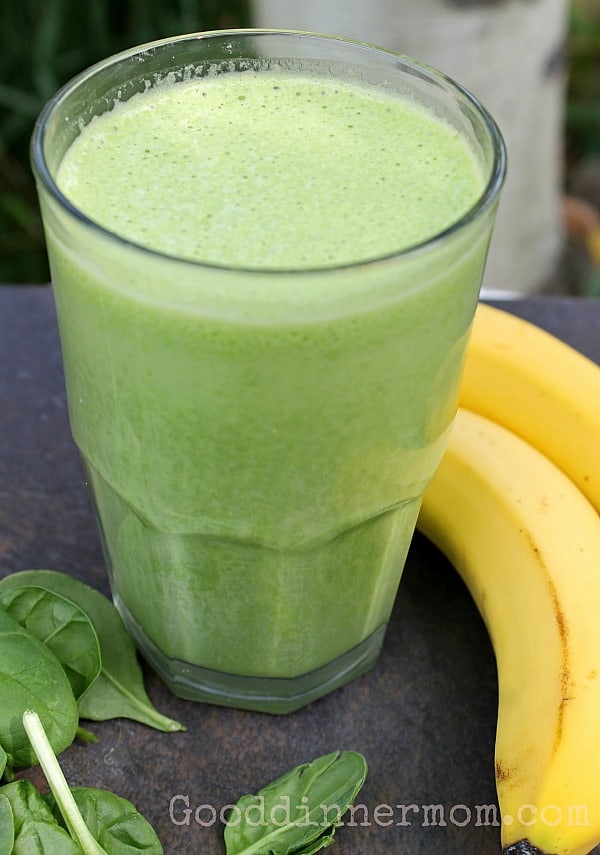 Green Banana Smoothie in a glass with bananas on the side