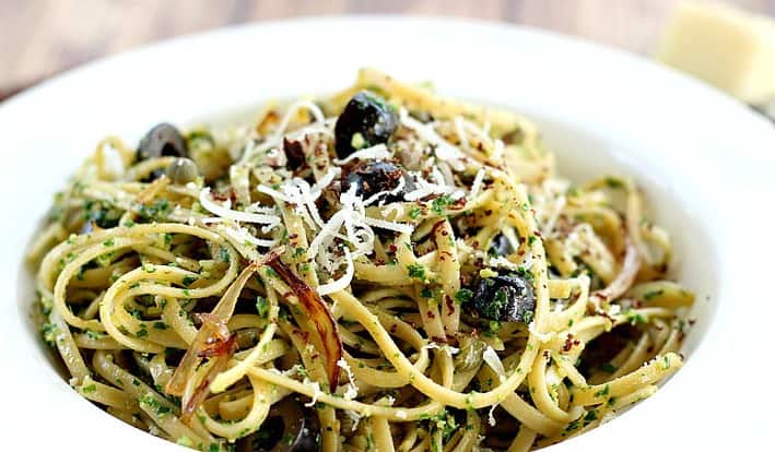 Kale Pesto with Black Olives and Capers served in white bowl