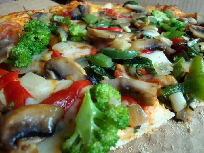 Close up of Pizza topped with vegetables