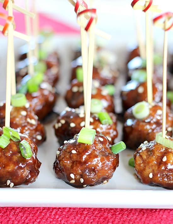 Slow Cooker Party Meatballs in Raspberry Balsamic Glaze with toothpicks and chives