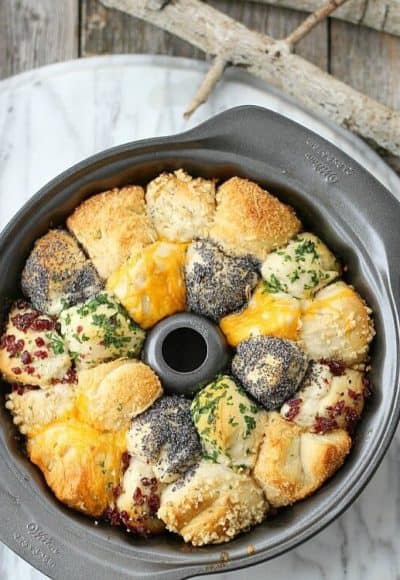 Incredible Savory Monkey Bread is buttery and flavorful, using refrigerated canister biscuits and any herb and cheese combination that fits your menu.