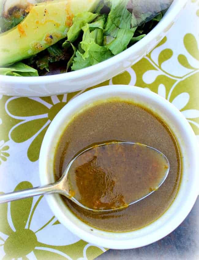 Orange Vinaigrette Salad Dressing in a white bowl with a spoon