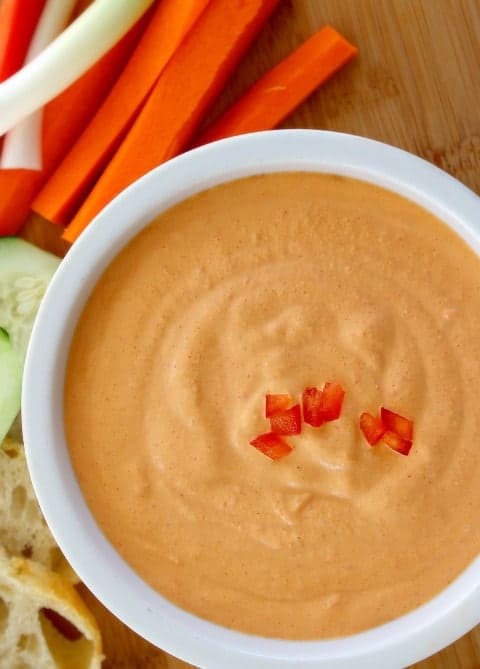 Red Pepper Jalapeño Cheese Dip in a white serving bowl with carrots on the side
