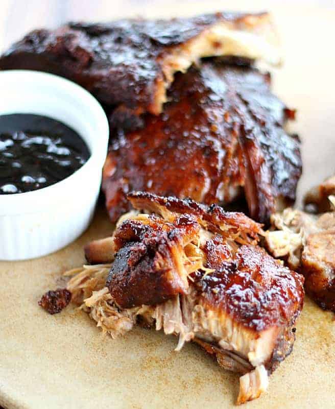 Best Baby Back Ribs on a platter, bbq sauce on the side