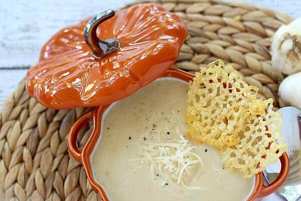 Roasted Garlic Soup in pumpkin bowl with Parmesan cheese crisps
