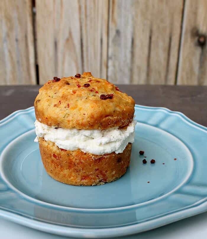 savory muffins cut in half with smoked salmon and cheddar cream cheese on a blue plate
