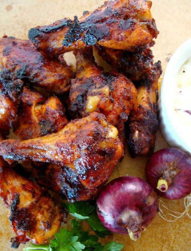  Ultimate Chicken Wing with dipping sauce and whole red onions on the side