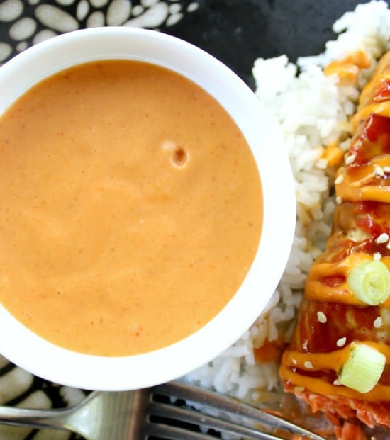Sriracha Cream Sauce in a bowl with salmon on the side 