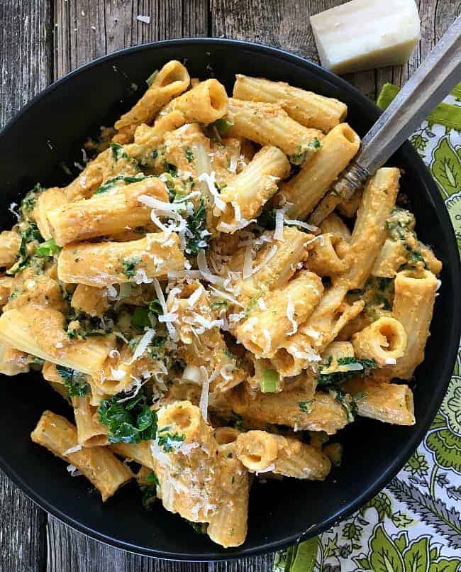 Pumpkin in this alfredo sauce replaces heavy cream with milk and reduces butter in the recipe. Healthy and tasty with Parmesan, cayenne, nutmeg and kale.