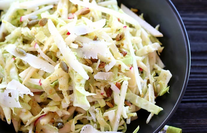 Up close of asian pear Cole slaw in black bowl