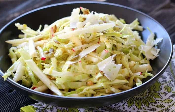 This Asian Pear Cole Slaw recipe is crispy-crunchy good and good-for-you with green cabbage, fennel, radishes, and Asian pear slices. Roasted pumpkin seeds and Manchego complement the Dijon lemon vinaigrette.