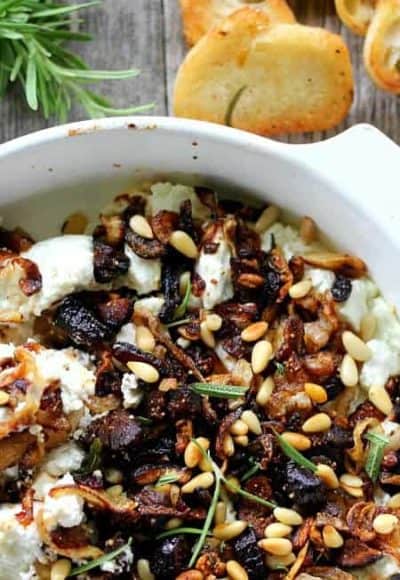 Baked Goat Cheese with caramelized onions, garlic and dried figs is an amazing appetizer with crostini or pears, and doubles as a fabulous topping for meat.