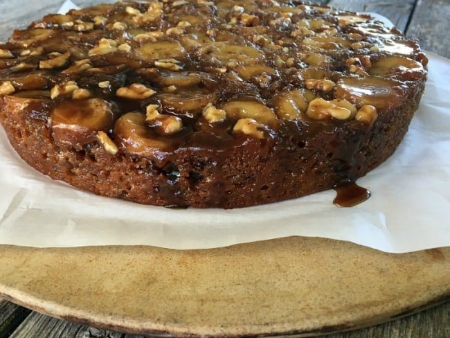  side view of banana upside down cake on parchment