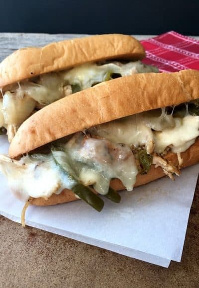 Chicken Philadelphia Cheese Steaks in the slow cooker come out juicy and tender. Top with provolone cheese and favorite spread.