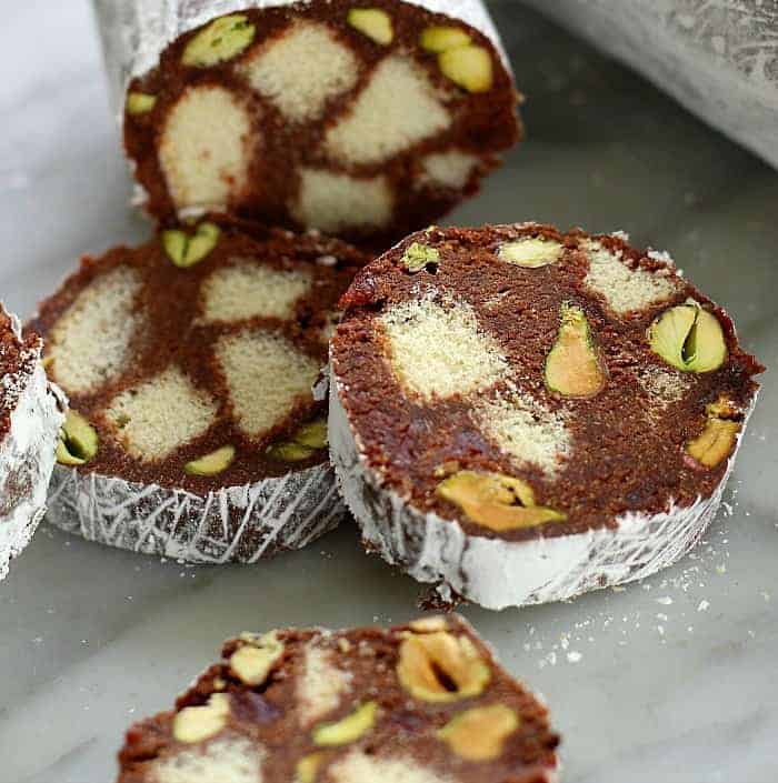 sliced chocolate cookies with cake pieces and pistachios inside