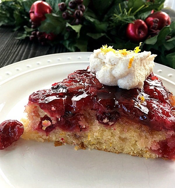Cranberry Upside Down Cake topped with Ricotta Cream on a white plate