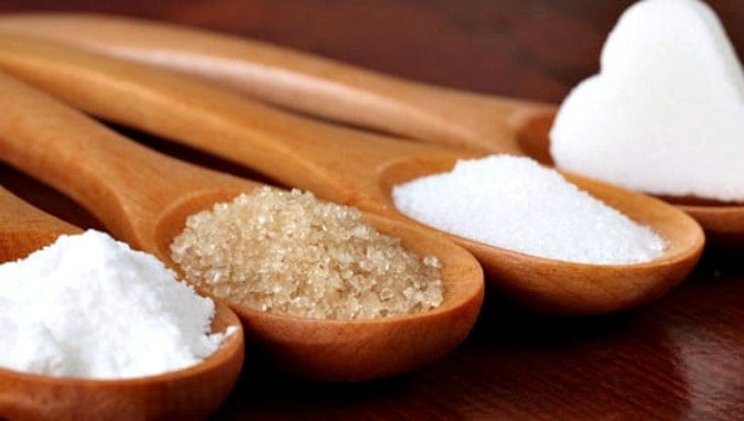 Different types of Sugars for a baking all on a wooden spoon
