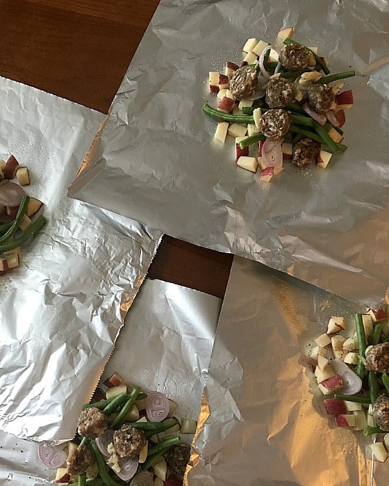 Four portioned out foil dinners ready to wrap