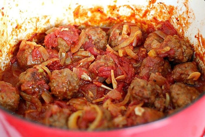 Meat, onions and sauce cooking in a pan