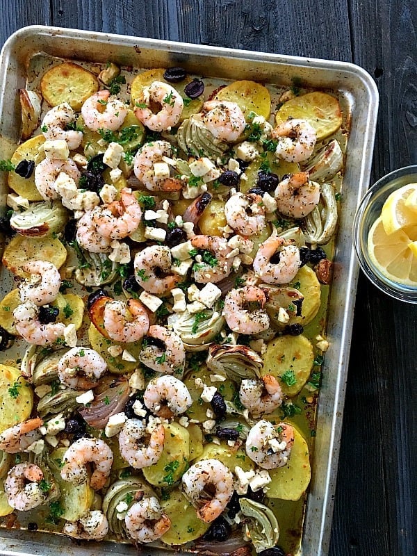 Mediterranean Shrimp Dinner is a perfect one pan recipe for weeknights or dinner parties. Oven roasted veggies topped with shrimp that's absolutely tender.