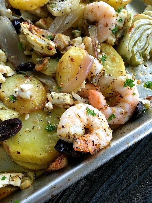 Mediterranean Shrimp Dinner is a perfect one pan recipe for weeknights or dinner parties. Oven roasted veggies topped with shrimp that's absolutely tender.