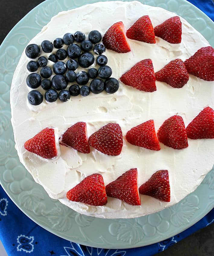 A fresh version of Poke Cake with whipped cream frosting and no artificial colors or gelatin. Only natural berry syrups. 