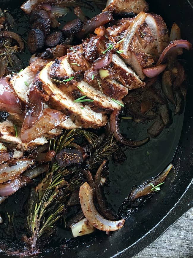 Pork Tenderloin with Figs, Red Onions and Rosemary close up, sliced in cast iron pan