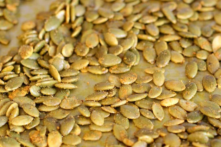 Turmeric Roasted Pumpkin Seeds on a baking sheet