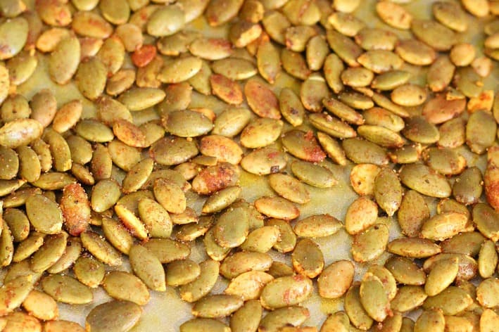 Turmeric Roasted Pumpkin Seeds combine healthy ingredients for a quick, irresistible snack or perfect salad topping. Sprinkle on your favorite vegetables for crunchy goodness.